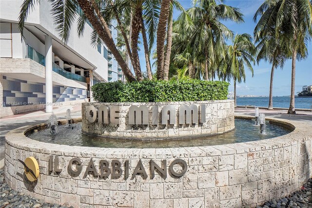 community sign featuring a water view