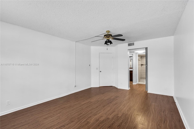 unfurnished room with ceiling fan, a textured ceiling, and dark hardwood / wood-style floors