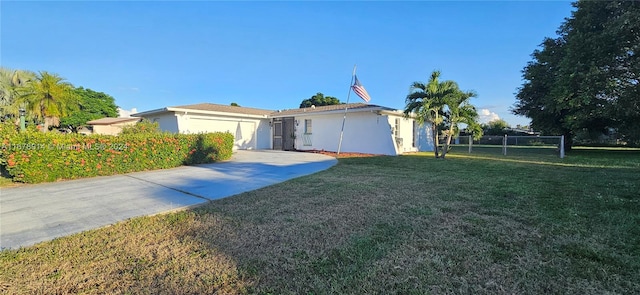 view of front of home with a front lawn and a garage