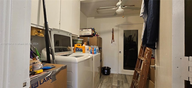 clothes washing area with cabinets, wood-type flooring, washing machine and dryer, and ceiling fan