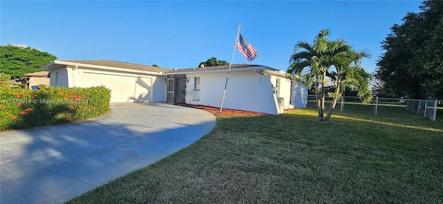 ranch-style home featuring a garage and a front lawn