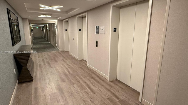 hall featuring light hardwood / wood-style flooring and elevator