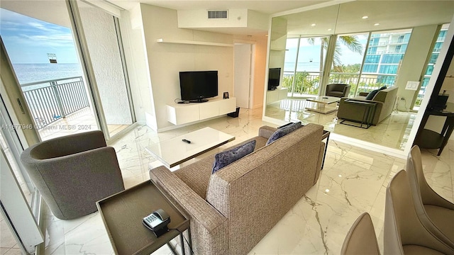 living room with a water view and a wall of windows