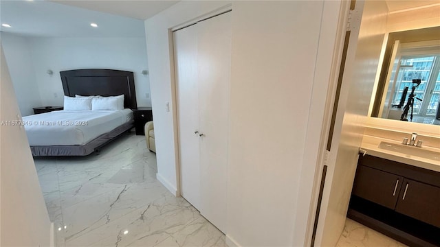 bedroom featuring a closet and sink