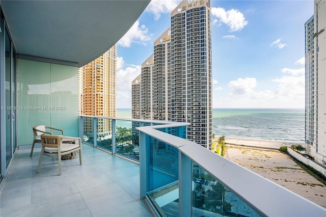 living room with a water view and a wall of windows