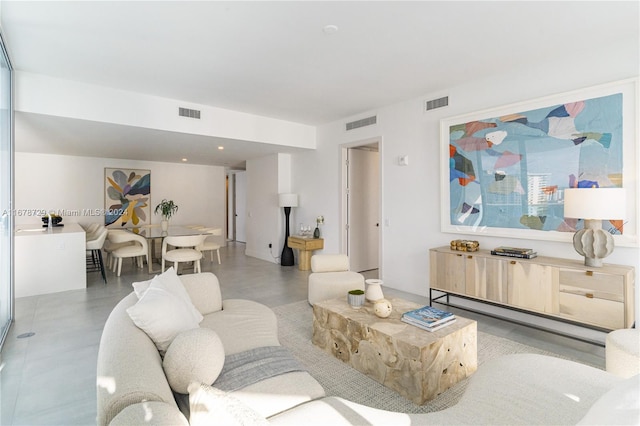 living room featuring a water view and expansive windows