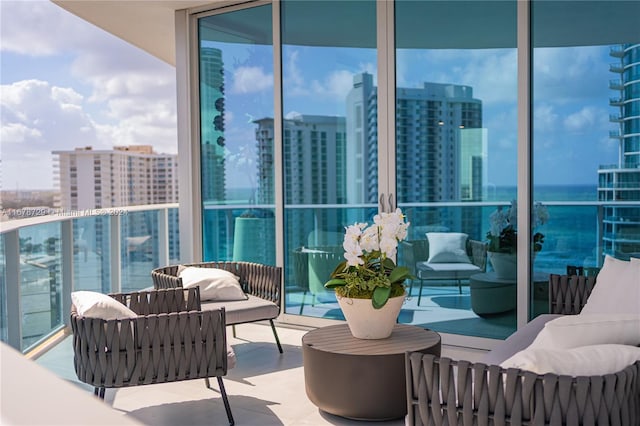 balcony featuring a water view and a view of the beach