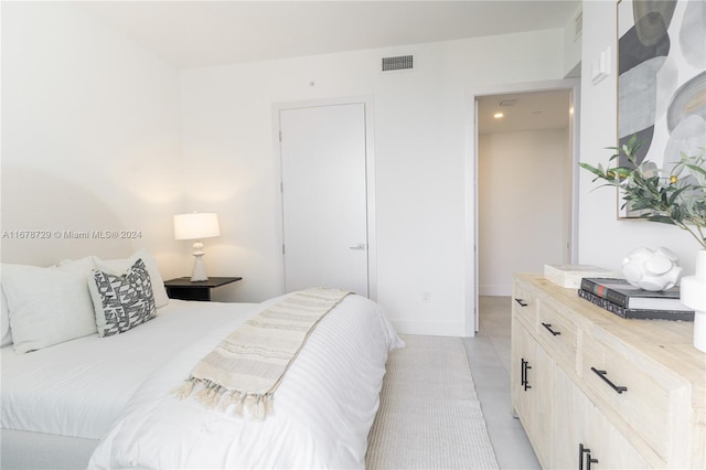 tiled bedroom with a closet