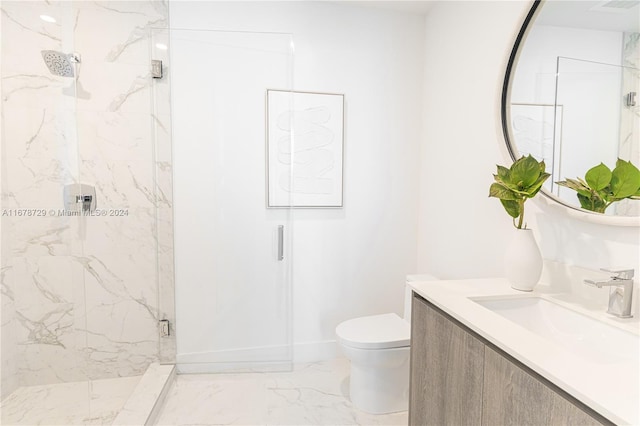 bathroom with vanity, a shower with shower door, and toilet