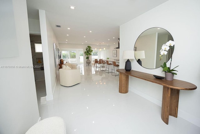 hall featuring light tile patterned floors