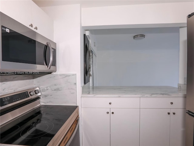 kitchen with white cabinets and appliances with stainless steel finishes