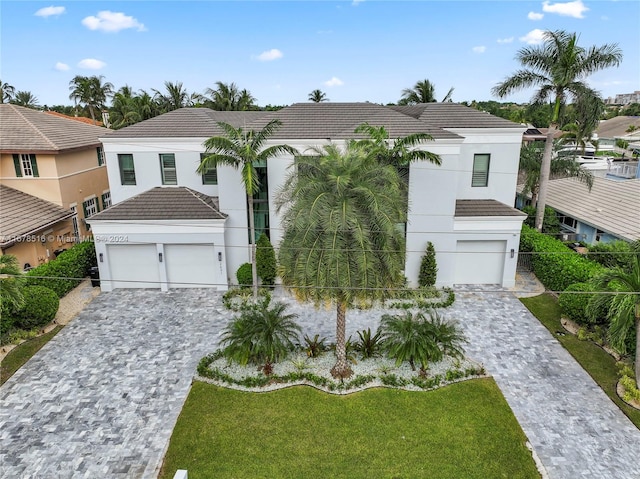 view of front of home featuring a garage and a front lawn