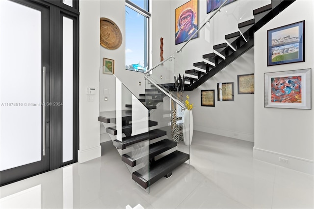 stairs featuring french doors and tile patterned flooring