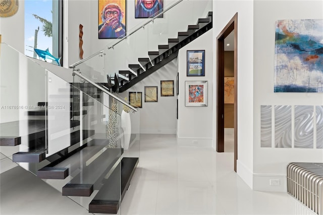 stairway with tile patterned floors