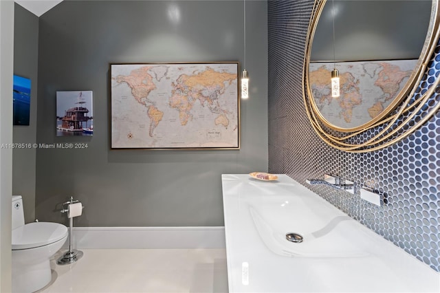 bathroom with toilet and tile patterned flooring