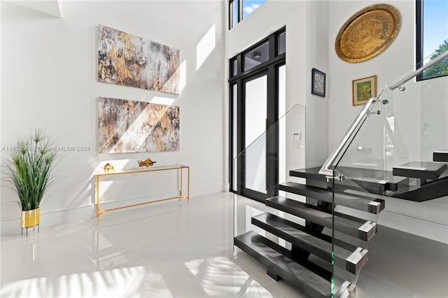 stairway with tile patterned floors