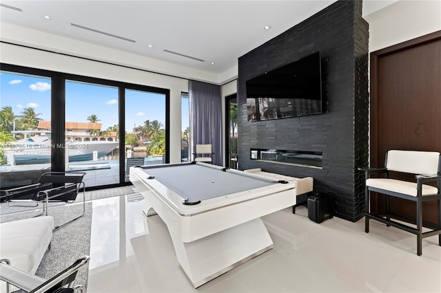 playroom with light tile patterned flooring, billiards, and a fireplace