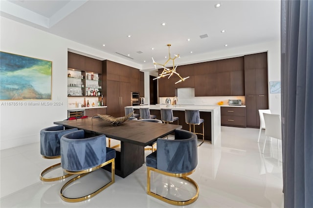 tiled dining room with a notable chandelier