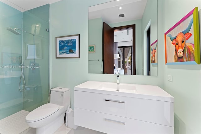 bathroom with vanity, toilet, and a shower with door