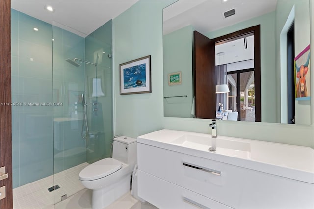 bathroom with vanity, toilet, and a shower with shower door