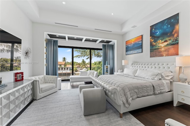 bedroom featuring access to exterior and wood-type flooring