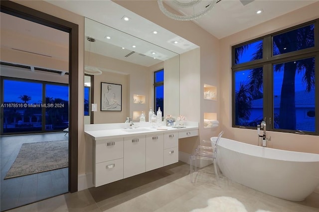 bathroom featuring vanity and a bath