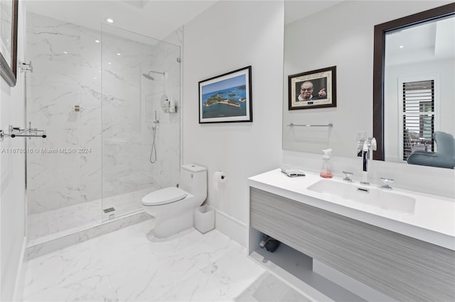 bathroom featuring toilet, vanity, and a shower with door