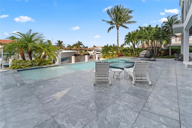 view of swimming pool with a patio