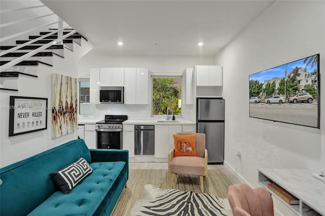 living room with light hardwood / wood-style flooring and sink