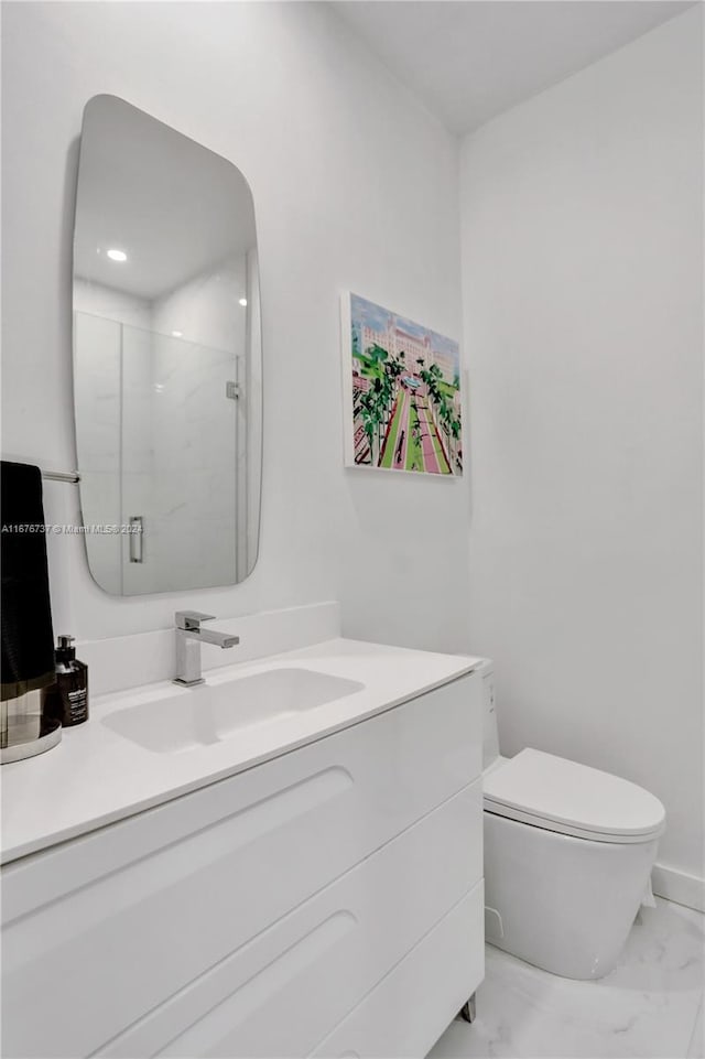 bathroom with toilet, an enclosed shower, and vanity