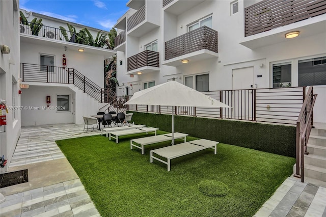 view of yard featuring a patio area and a balcony