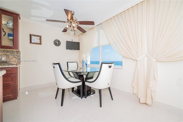 dining space featuring ceiling fan and ornamental molding