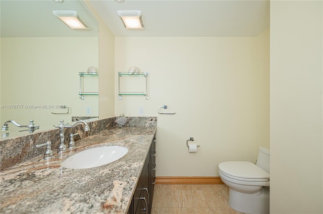 bathroom featuring tile patterned floors, vanity, and toilet