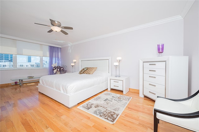 bedroom featuring ceiling fan, crown molding, and light hardwood / wood-style floors