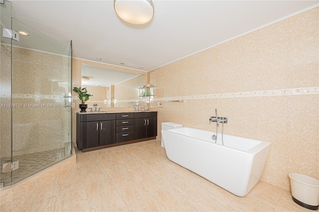 bathroom with separate shower and tub, vanity, and tile walls