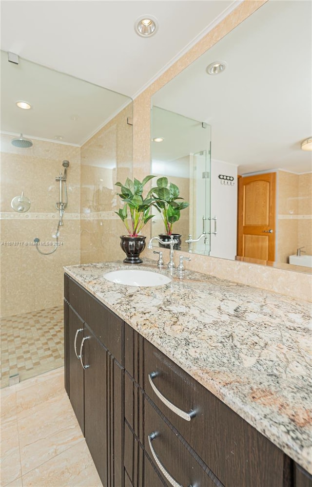 bathroom with vanity and tiled shower