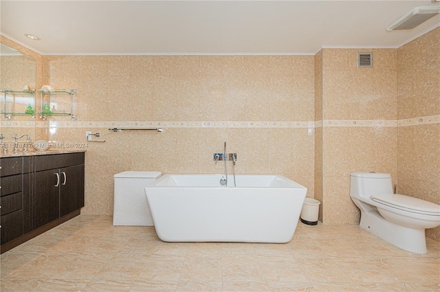 bathroom featuring ornamental molding, vanity, tile walls, toilet, and a tub