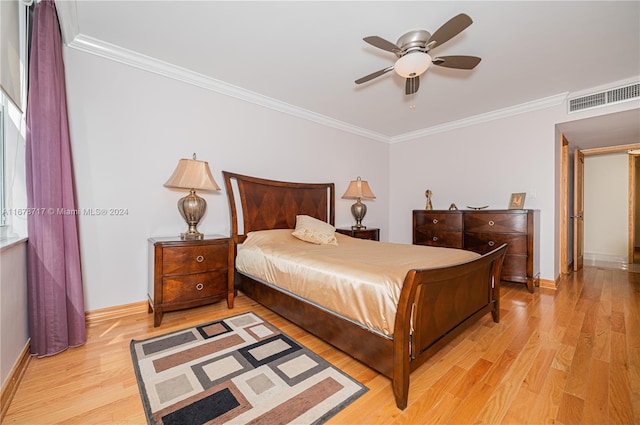 bedroom featuring ceiling fan, ornamental molding, and light hardwood / wood-style flooring