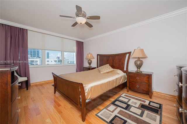 bedroom featuring light hardwood / wood-style flooring, ceiling fan, and ornamental molding