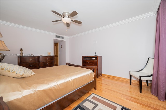 bedroom with hardwood / wood-style floors, ceiling fan, and crown molding