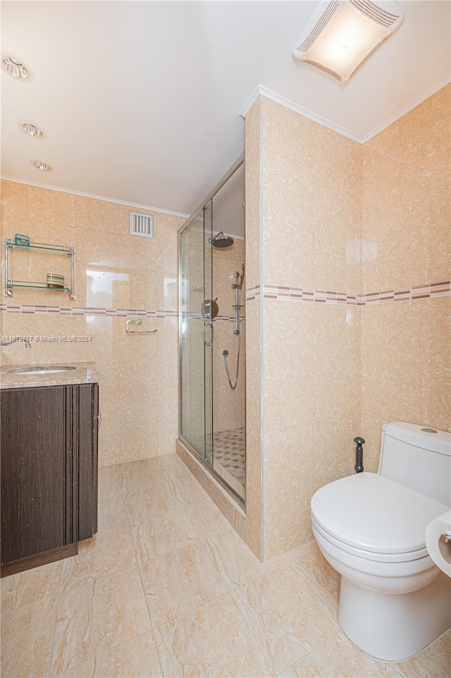 bathroom with a shower with door, tile walls, and toilet