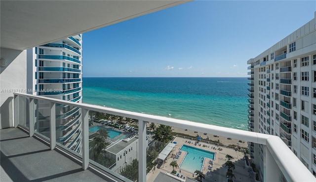 balcony with a water view and a beach view