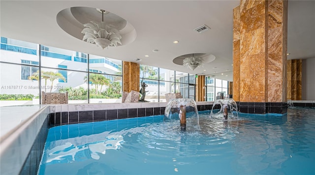 view of swimming pool featuring pool water feature