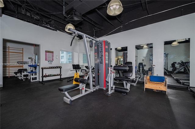 gym with a towering ceiling