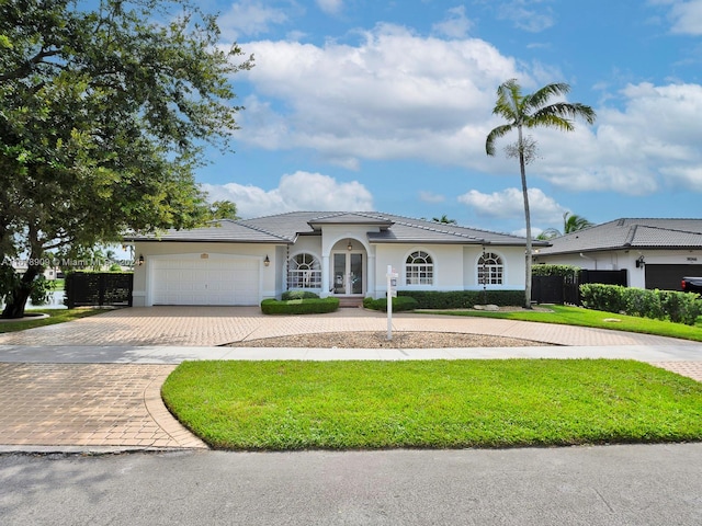 view of front of property featuring a front yard and a garage