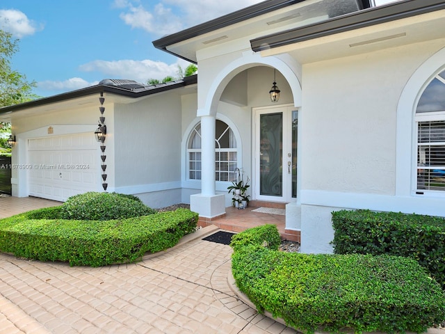 doorway to property with a garage