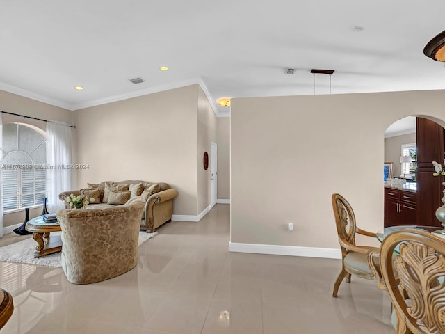 living room with crown molding and light tile patterned floors