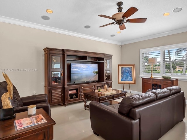 living room featuring ceiling fan, ornamental molding, and a textured ceiling