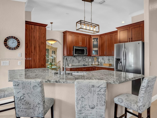 kitchen featuring kitchen peninsula, ornamental molding, sink, appliances with stainless steel finishes, and light stone counters