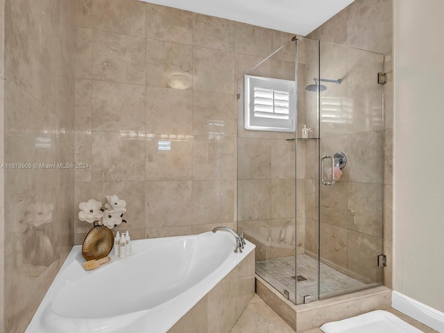 bathroom featuring separate shower and tub